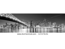 Stock-photo-queensboro-bridge-over-new-york-city-east-river-black-and-white-at-night-with-river-reflections-and-117473134.jpg