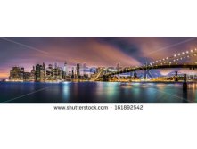 Stock-photo-lower-manhattan-and-the-brooklyn-bridge-under-a-cloudy-sky-at-dawn-as-viewed-from-the-brooklyn-161892542.jpg