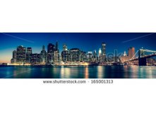 Stock-photo-new-york-panoramic-view-of-manhattan-skyline-by-night-165001313.jpg