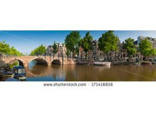 Stock-photo-pretty-dutch-doll-houses-and-house-boats-reflected-in-the-tranquil-canals-of-amsterdam-holland-171416816.jpg