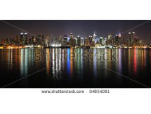 Stock-photo-new-york-city-manhattan-midtown-skyline-panorama-at-night-with-lights-reflection-over-hudson-river-94854091.jpg