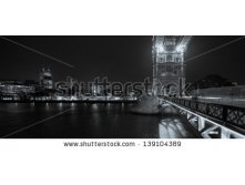 Stock-photo-black-and-white-panorama-of-tower-bridge-and-tower-prison-in-london-capital-of-the-uk-at-night-139104389.jpg