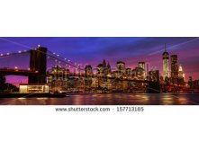 Stock-photo-panorama-of-brooklyn-bridge-east-river-and-manhattan-at-sunset-with-lights-and-reflections-new-157713185.jpg