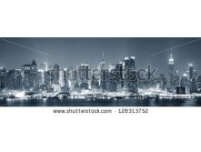 Stock-photo-new-york-city-manhattan-midtown-skyline-black-and-white-at-night-with-skyscrapers-lit-over-hudson-128313752.jpg