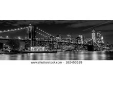 Stock-photo-brooklyn-bridge-with-manhattan-skyline-in-the-background-at-night-in-black-and-white-162453629.jpg