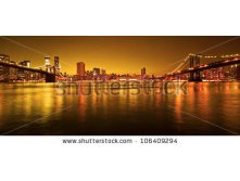 Stock-photo-manhattan-bridge-and-manhattan-skyline-at-night-106409294.jpg