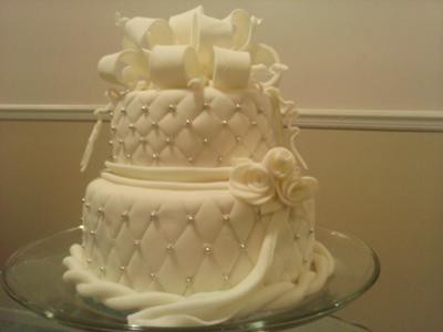 quilted-white-two-tiered-wedding-cake-with-bow-21184609.jpg
