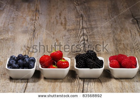 Stock-photo-row-of-wild-berries-in-bowls-on-wooden-background-83568892.jpg