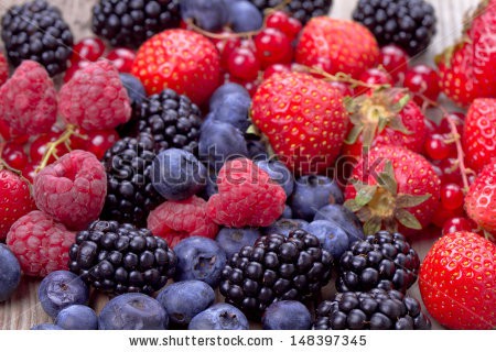 Stock-photo-mixed-berries-over-wooden-background-148397345.jpg