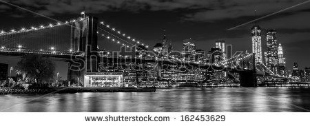 Stock-photo-brooklyn-bridge-with-manhattan-skyline-in-the-background-at-night-in-black-and-white-162453629.jpg