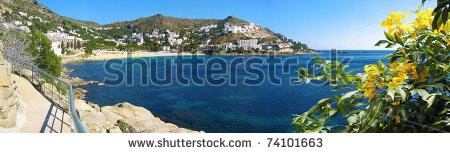 Stock-photo-panorama-over-cala-canyelles-petites-bay-with-flowers-in-foreground-mediterranean-sea-rosas-74101663.jpg