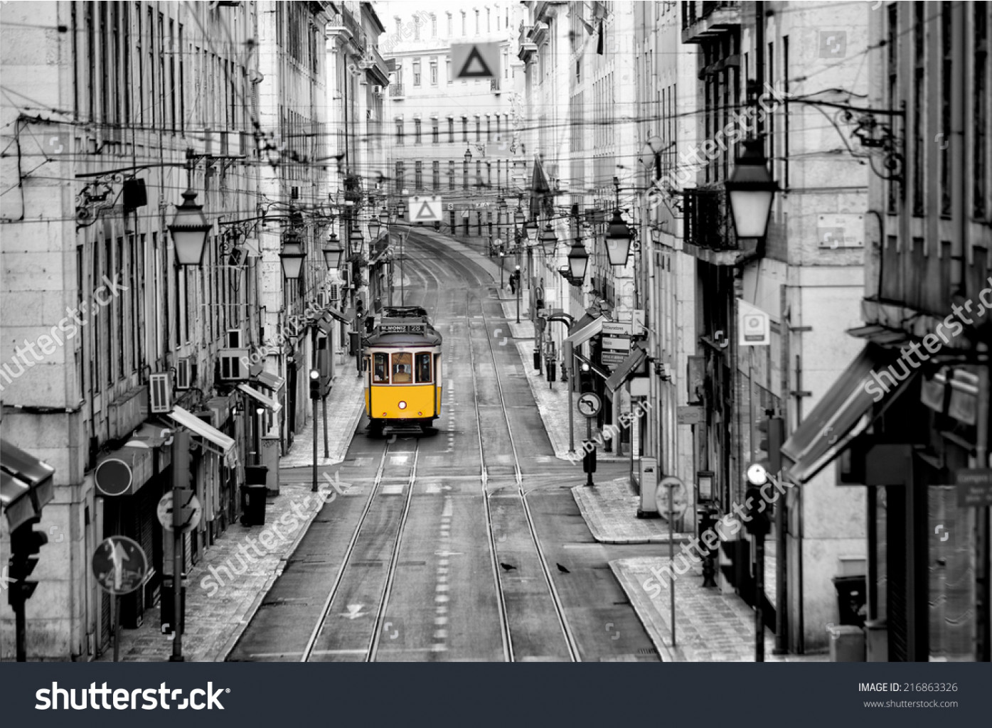 Stock-photo-famous-yellow-tram-in-the-streets-of-lisbon-capital-of-portugal-in-the-early-morning-with-no-216863326.jpg