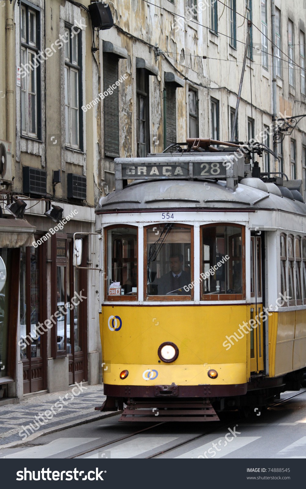 Stock-photo-lisbon-portugal-march-old-yellow-tram-on-the-street-of-lisbon-portugal-at-march-74888545.jpg